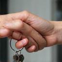 Giving keys to a client, symbolizing completion